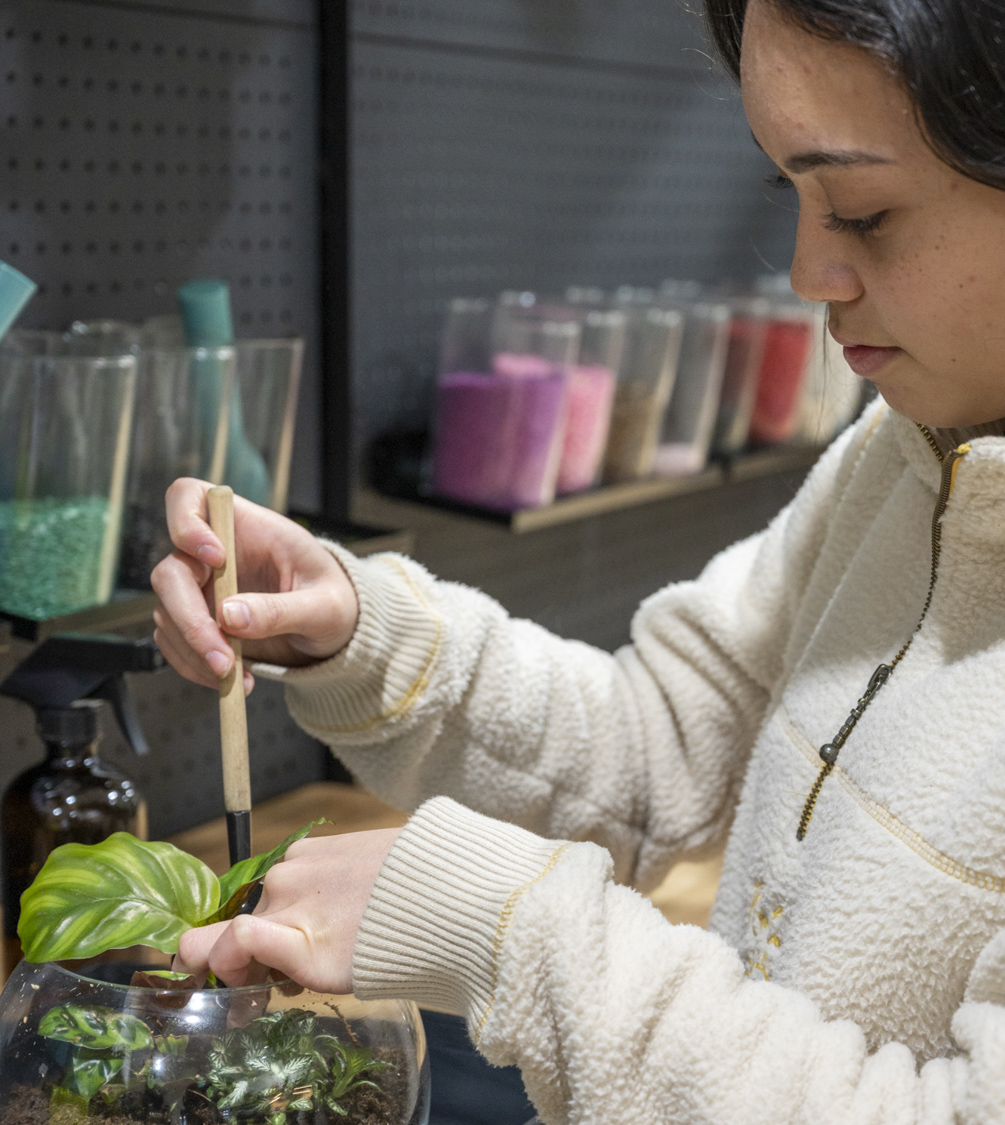 Girl doing a plan terrarium at Botanista Port Noarlunga