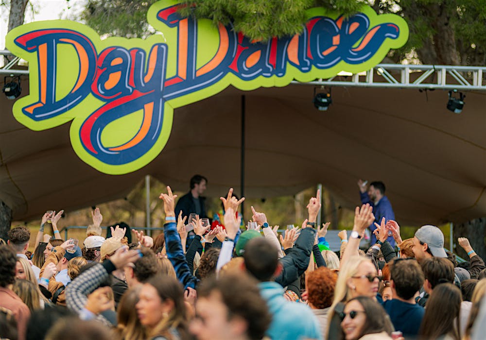 A crowd dancing in front of the day dance sign in McLaren Vale