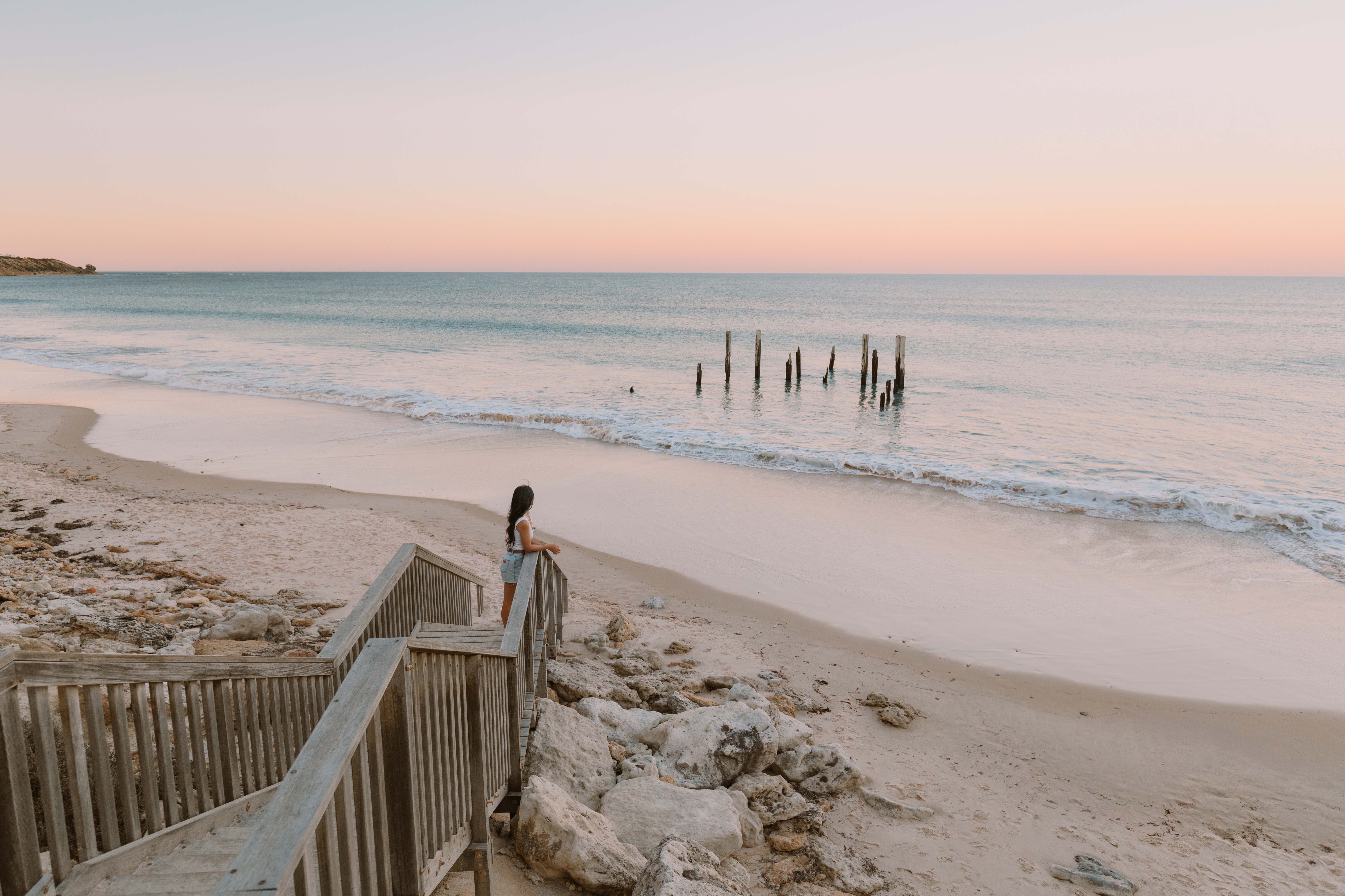 Port Willunga Beach with a girl standing on the steps looking at the ocean