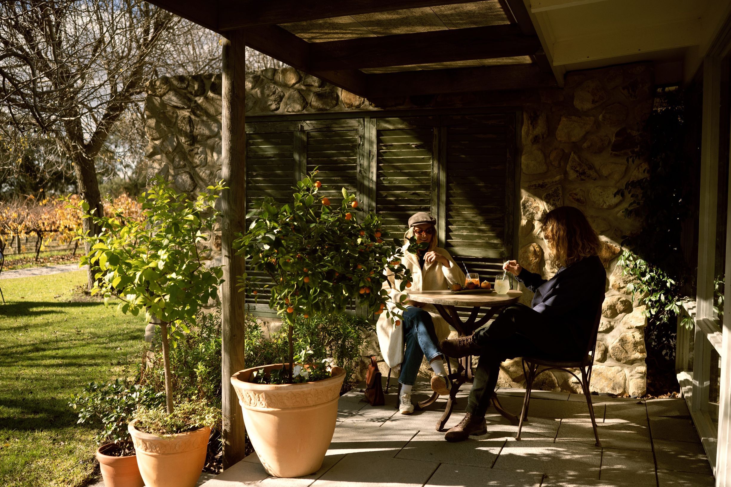 Man and Lady sitting at a restarant outside on chairs in McLaren Vale