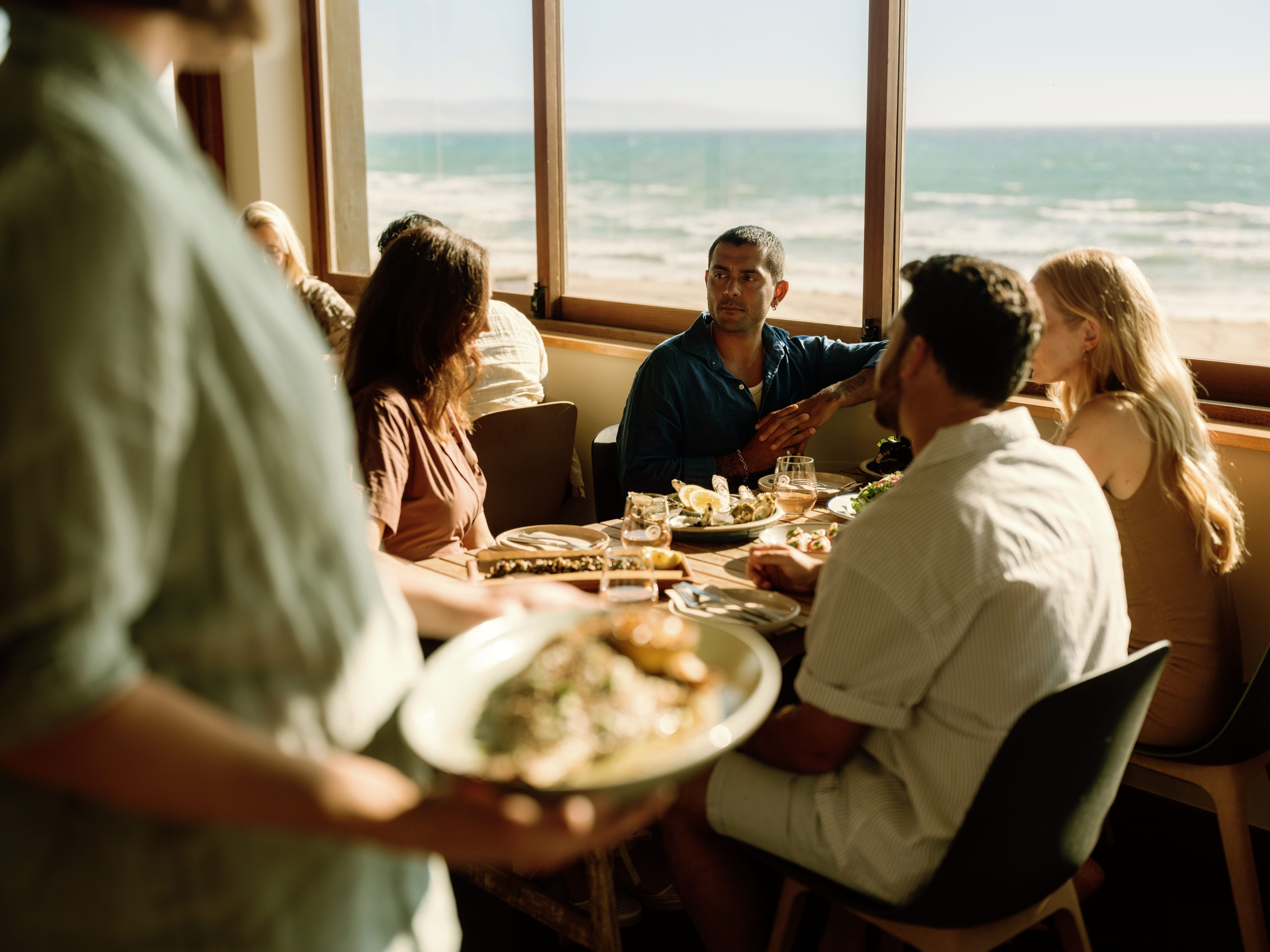 Diners enjoying a feed me menu with ocean views at Pearl, Aldinga Beach